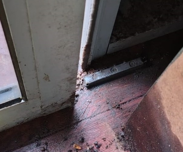 Worn and misaligned commercial sliding door guides